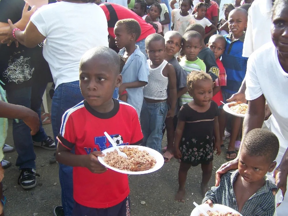 A group of children standing around eating food.